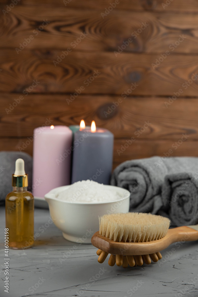 Herbal therapy, traditional medicine and homeopathy concept. Towel with salt, herbs, massage brush, candles and bottle natural organic oil essence serum. Set for spa, massage and aromatherapy Herbal therapy, traditional medicine and homeopathy concept. Towel with salt, herbs, massage brush, candles and bottle natural organic oil essence serum. Set for spa, massage and aromatherapy