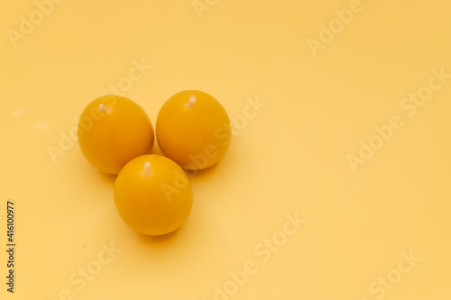 Yellow candle from beeswax in the form of egg for celebrating Easter.