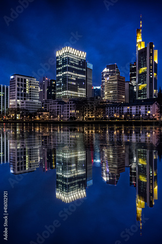 Skyline in Frankfurt. unique light in a great city on the river Main. Reflection in the water. Street photography, puddles, views, gorges and architecture © Jan