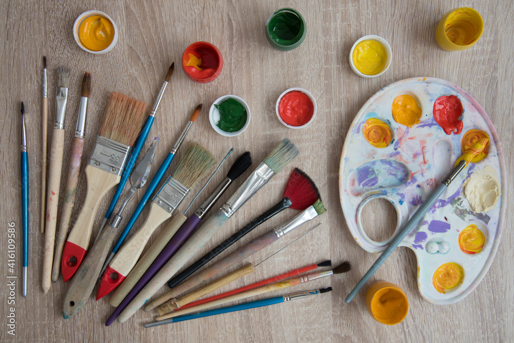 Background, texture. Top view of the artist's easel, gouache and brushes Background, texture. Top view of the artist's easel, gouache and brushes