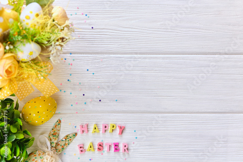 Colorful easter basket on a white wooden background