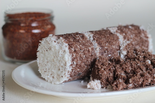 Steamed finger millet cake. Made with finger millet flour combined with grated cocunut and steamed in a special container photo