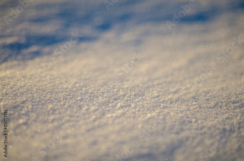 close up white snow in winter at sunset, snowy background