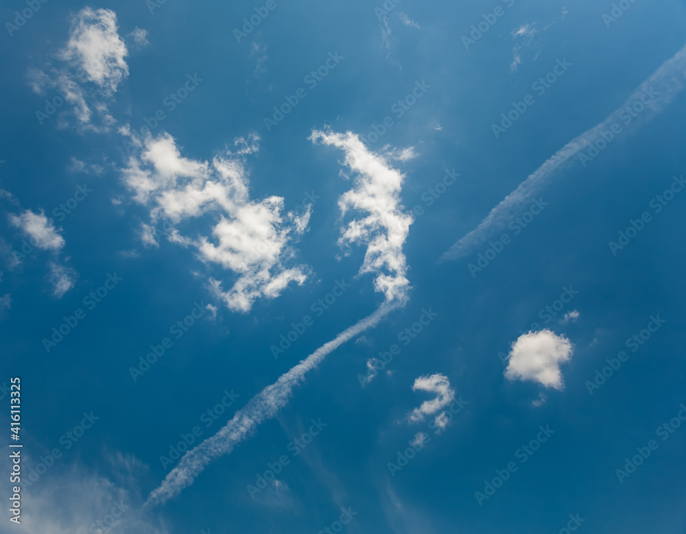 A sky with white clouds and beautiful sunbeams passing through the clouds. The magical beauty of the sky with the sun and clouds
