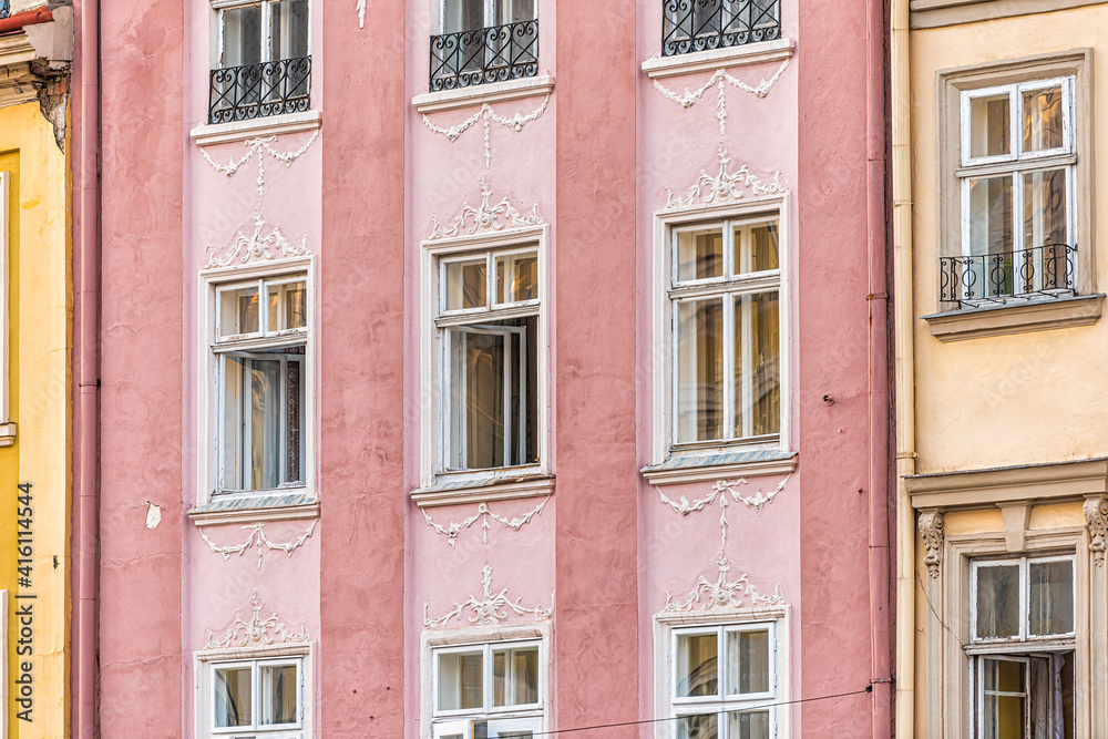Obraz premium Lviv, Ukraine pink color wall pattern in historic Ukrainian Lvov city with colorful buildings abstract architecture on street in old town market square