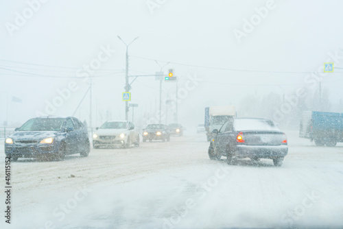 loaded with traffic highway during massive snowfall, cars, pedestrian, road