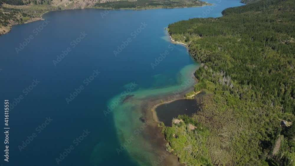 Aerial high angle of turquoise Epuyen lake surrounded by pine tree woods, Patagonia Argentina Aerial high angle of turquoise Epuyen lake surrounded by pine tree woods, Patagonia Argentina