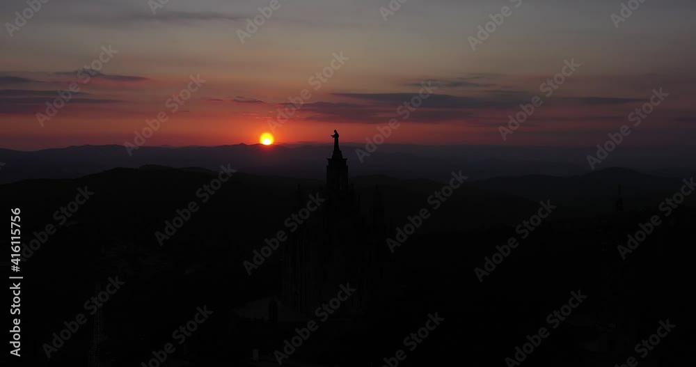 Aerial video front dolly movement of sunset in barcelona with tibidabo church in silhouette Aerial video front dolly movement of sunset in barcelona with tibidabo church in silhouette