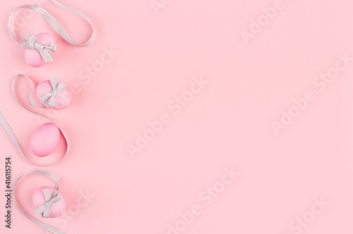 Sweet easter background - easter eggs with silver ribbon tracks as border on pastel pink color. © finepoints
