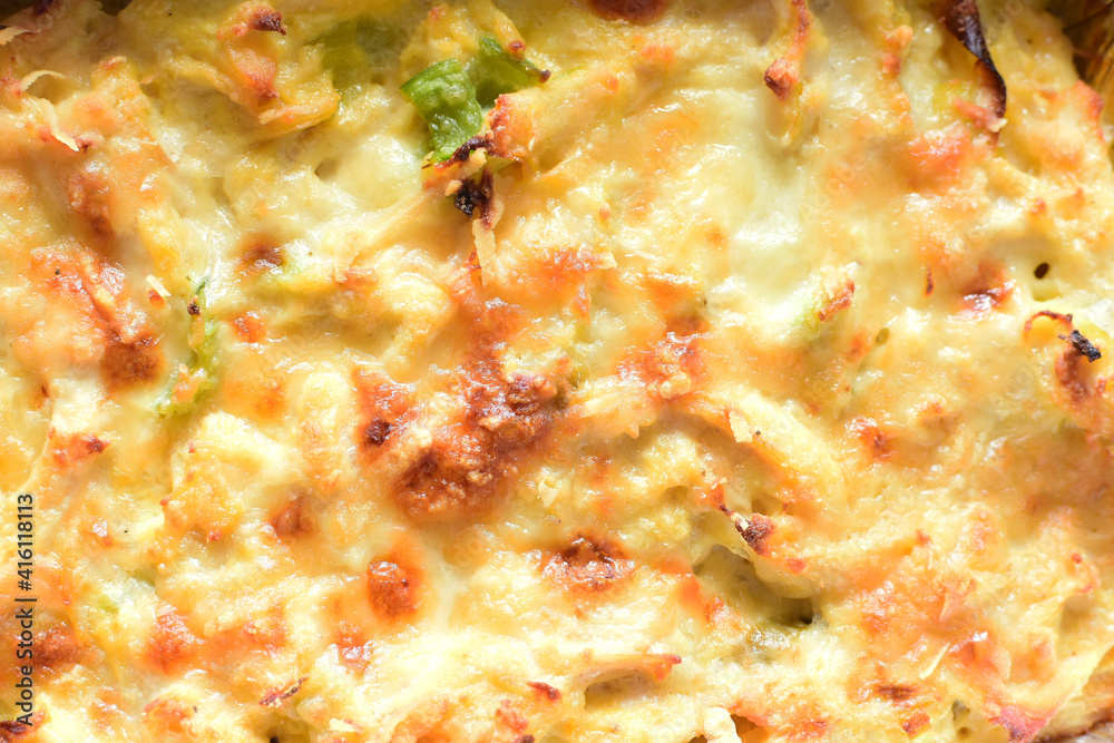 Baked chicken and mushroom cannelloni, bathed in cream in cheese sauce gratin on white wooden background Baked chicken and mushroom cannelloni, bathed in cream in cheese sauce gratin on white wooden background