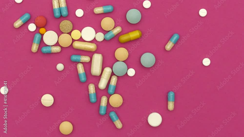 Top view of assorted pills spilling on table Top view of assorted pills spilling on table