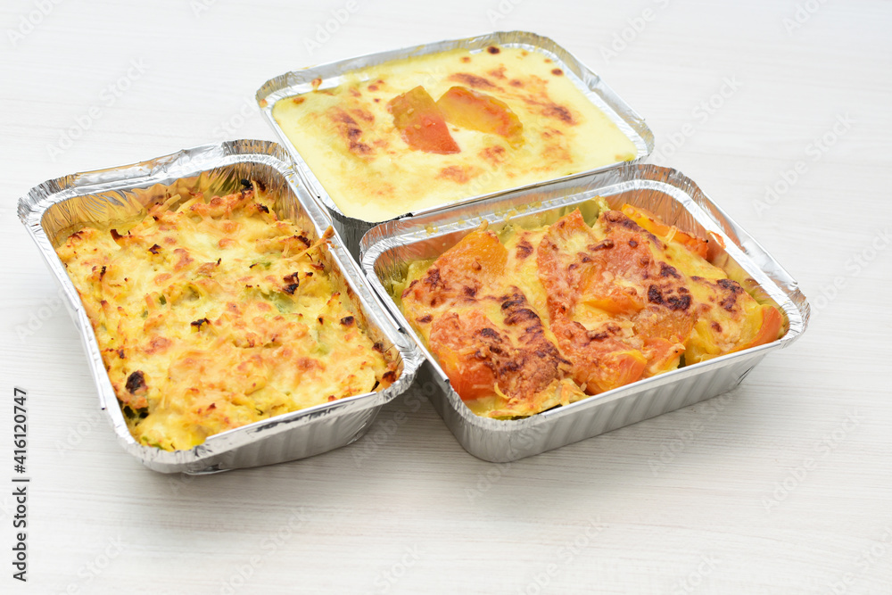 Baked chicken and mushroom cannelloni, bathed in cream in cheese sauce gratin on white wooden background Baked chicken and mushroom cannelloni, bathed in cream in cheese sauce gratin on white wooden background