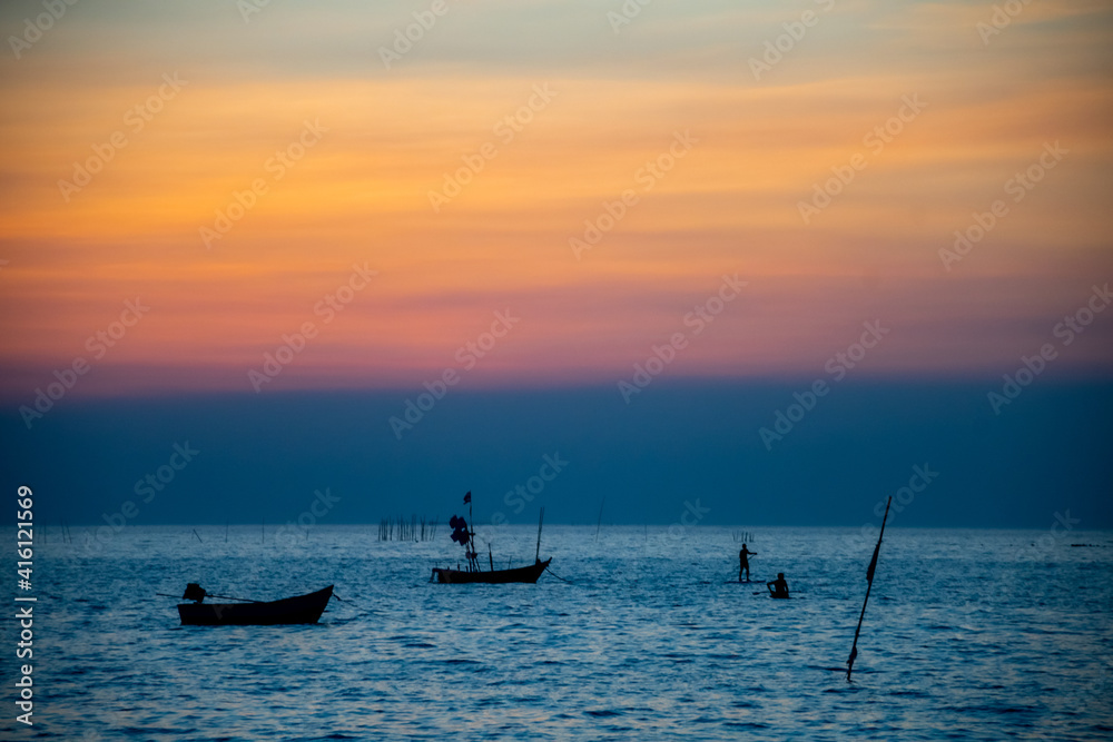 silhouette of fishing boats against sunset silhouette of fishing boats against sunset