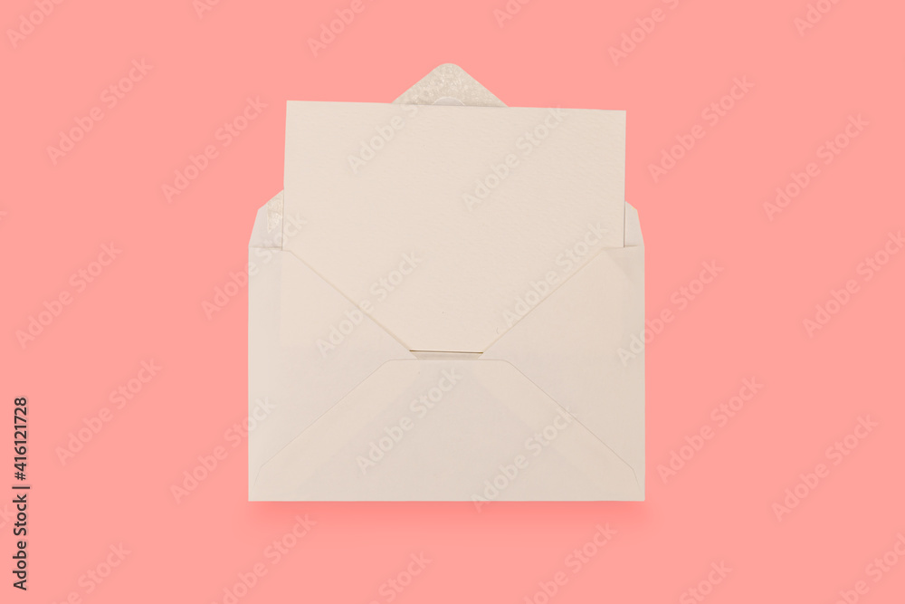 Simple small envelope with space for writing on a colourful pink background. close-up. Flat lay. Holiday and best wishes concept. Simple small envelope with space for writing on a colourful pink background. close-up. Flat lay. Holiday and best wishes concept.