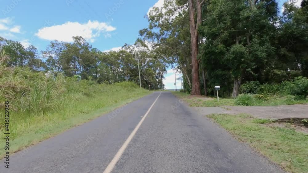 Rear facing driving point of view POV of a deserted and dead straight Queensland country lane in the Glasshouse Mountains - ideal for interior car scene green screen replacement Rear facing driving point of view POV of a deserted and dead straight Queensland country lane in the Glasshouse Mountains - ideal for interior car scene green screen replacement