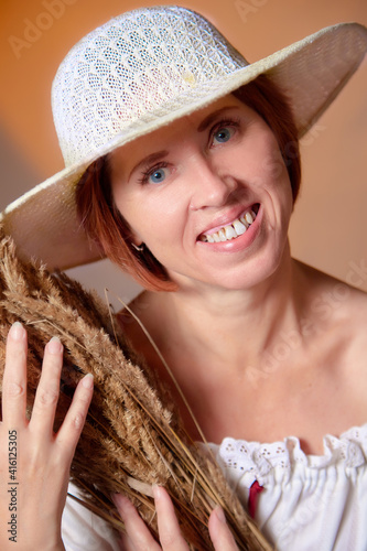 Portrait of ugle middle-aged woman with hat. A model posing in a rustic style in a Studio. photo