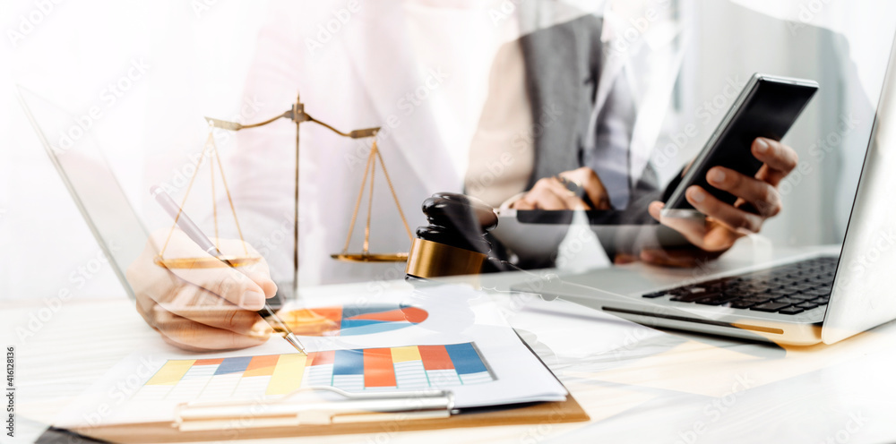 Business and lawyers discussing contract papers with brass scale on desk in office. Law, legal services, advice, justice and law concept picture with film grain effect Business and lawyers discussing contract papers with brass scale on desk in office. Law, legal services, advice, justice and law concept picture with film grain effect