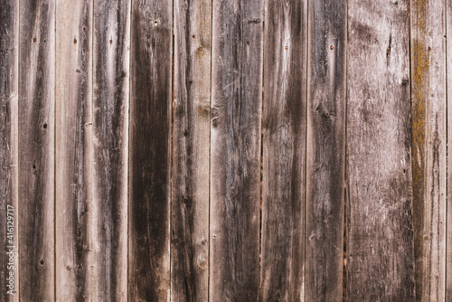 Old wooden boards in the form of a wall or wooden fence, authentic background from wooden boards