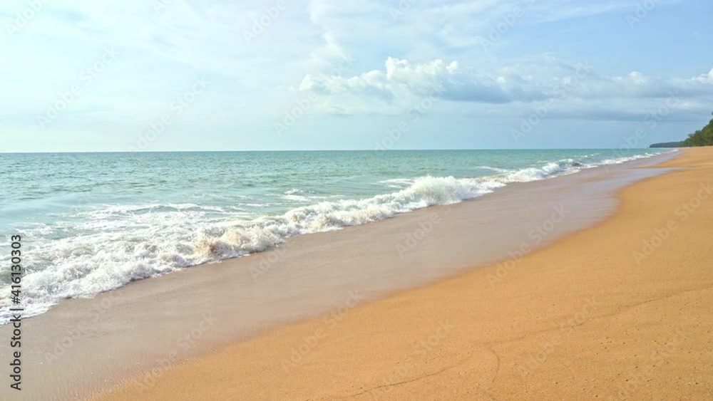 Slow motion of sea waves breaking on empty sandy exotic tropical beach, full frame wide view Slow motion of sea waves breaking on empty sandy exotic tropical beach, full frame wide view