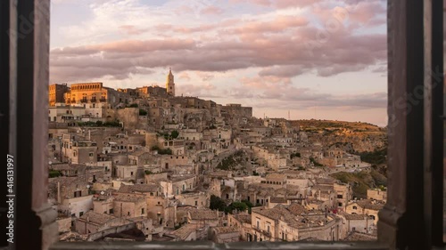 sassi di matera old town skyline timelapse from day to night seen from a window,time lapse of italian historic city at the sunset photo