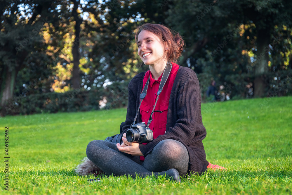 Girl photographing at public park with SLR camera Girl photographing at public park with SLR camera