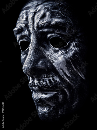 Creepy man head mask on black background