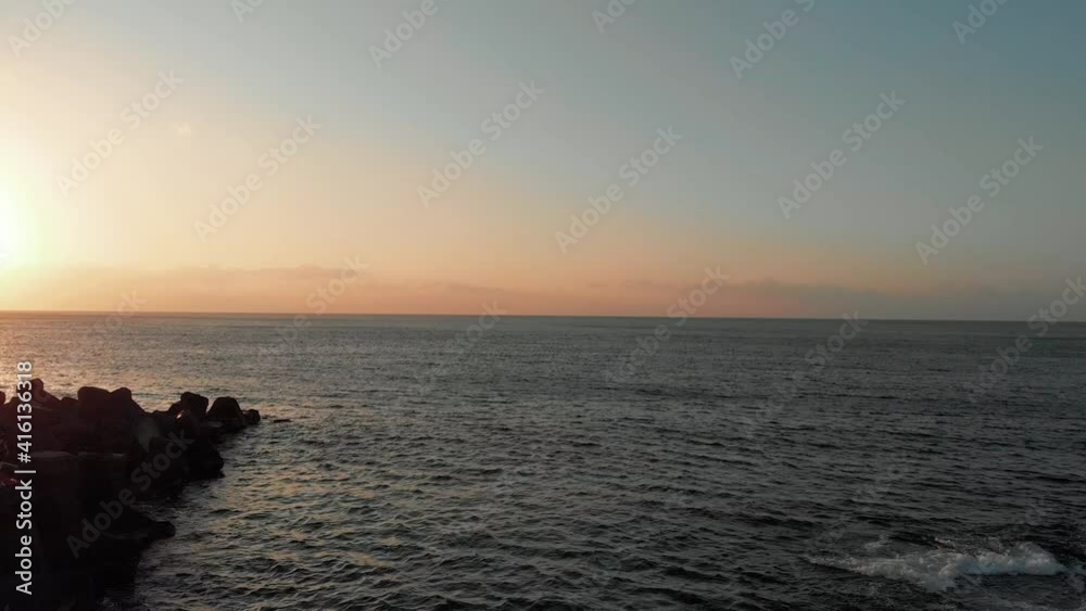 Silhouette of fisherman fishing from pier at sunset. Aerial forward ascending Silhouette of fisherman fishing from pier at sunset. Aerial forward ascending
