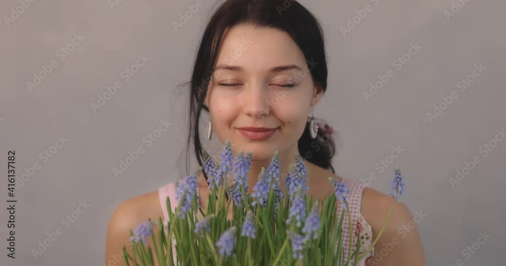 Woman Holding Bouquet of Flowers in Hands Indoors