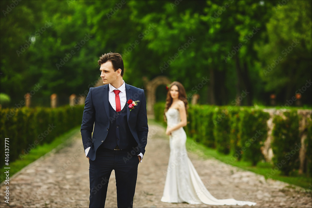 Stylish groom waiting for the meeting with her bride. Couple before the wedding ceremony Stylish groom waiting for the meeting with her bride. Couple before the wedding ceremony