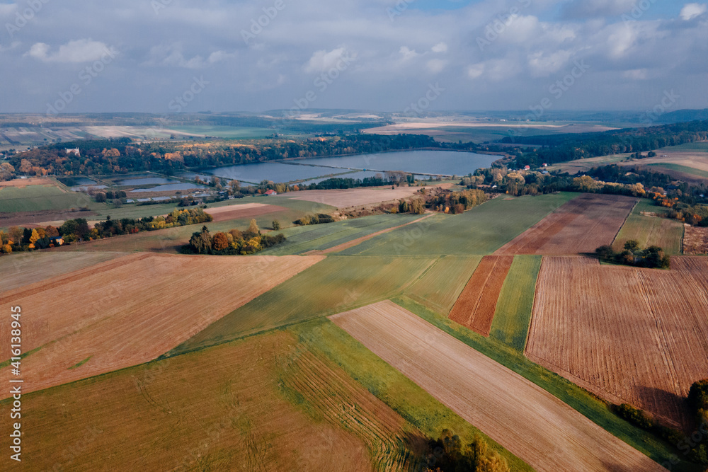 View of autumn forest and farmlands fields