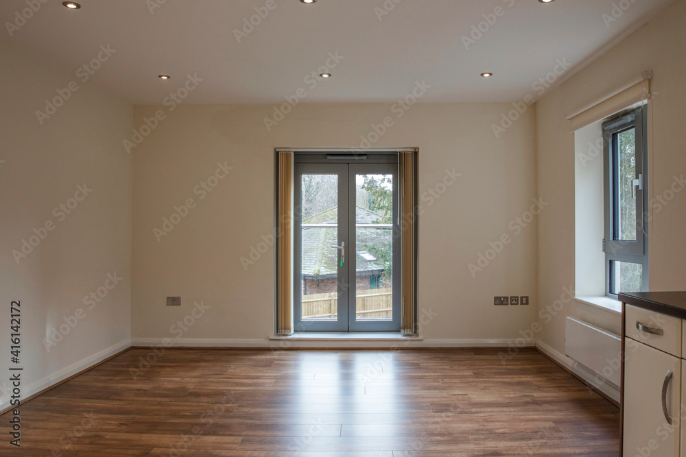 Fototapeta premium View of an empty living room area in a modern apartment with wooden flooring