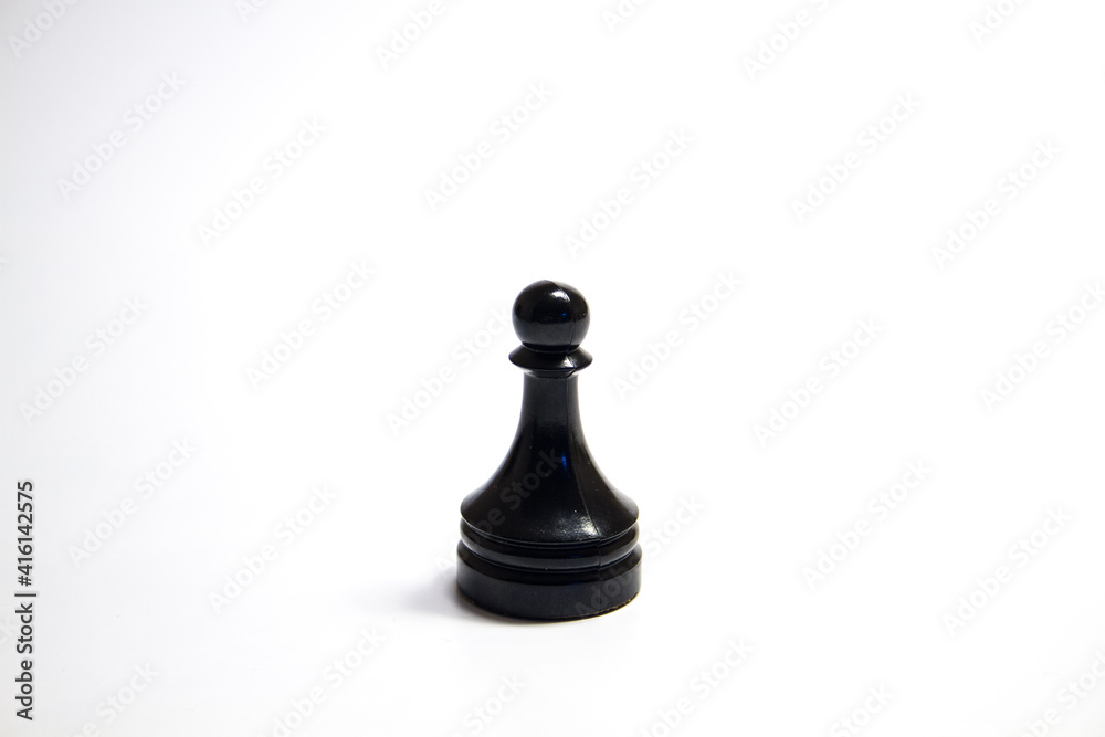 A black chess piece is a pawn isolated on a white background A black chess piece is a pawn isolated on a white background