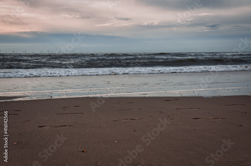 beach at sunset with waves and surf Wijk aan Zee castricum