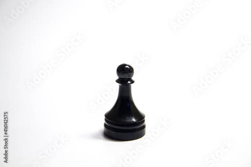 A black chess piece is a pawn isolated on a white background