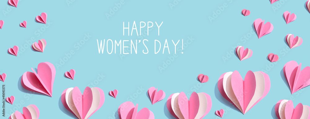 Happy women's day message with pink paper hearts - flat lay Happy women's day message with pink paper hearts - flat lay