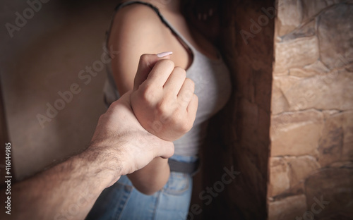 Obraz na plátně Angry male hand holding a woman hand. Abuse victim
