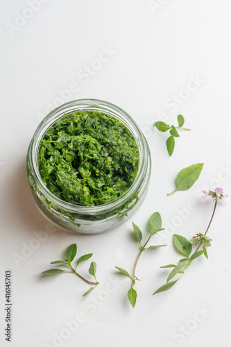 pesto sauce in a jar on a white background