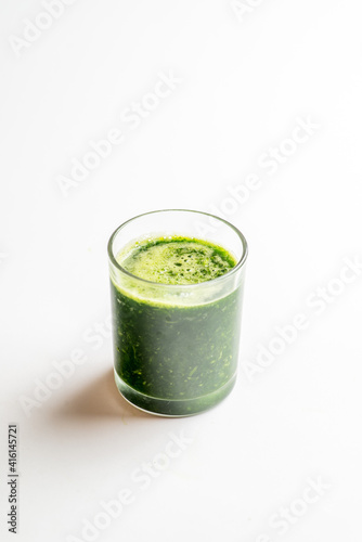 glass with green spinach smoothie. Vegan and raw food cocktail
