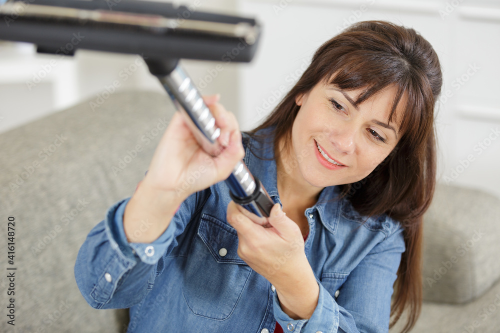 woman hoovering at someones house woman hoovering at someones house
