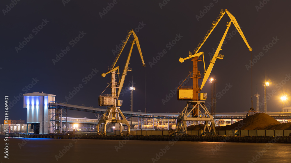 Night photo with port cranes in yellow over the Venta canal in Ventspils. Night photo with port cranes in yellow over the Venta canal in Ventspils.