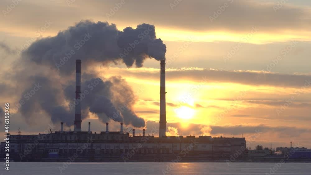 Plant pipes pollute atmosphere. Industrial factory pollution, smokestack exhaust gases. Industry zone, thick smoke plumes. Climate change, ecology global warming. Plant pipes pollute atmosphere. Industrial factory pollution, smokestack exhaust gases. Industry zone, thick smoke plumes. Climate change, ecology global warming.
