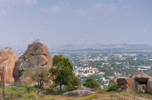 Chitradurga, Karnataka, India - November 10, 2013: Fort or Elusuttina Kote. Looking east over cityscape in valley from Siddeshwara cave temple site under light blue sky.  photo