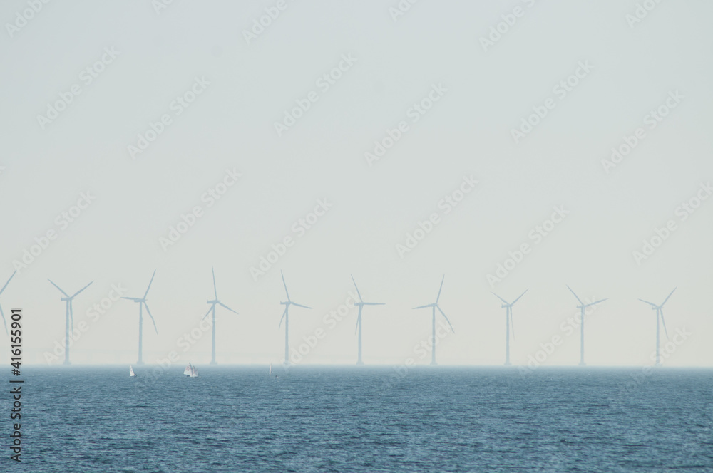 wind power station in the sea and boats