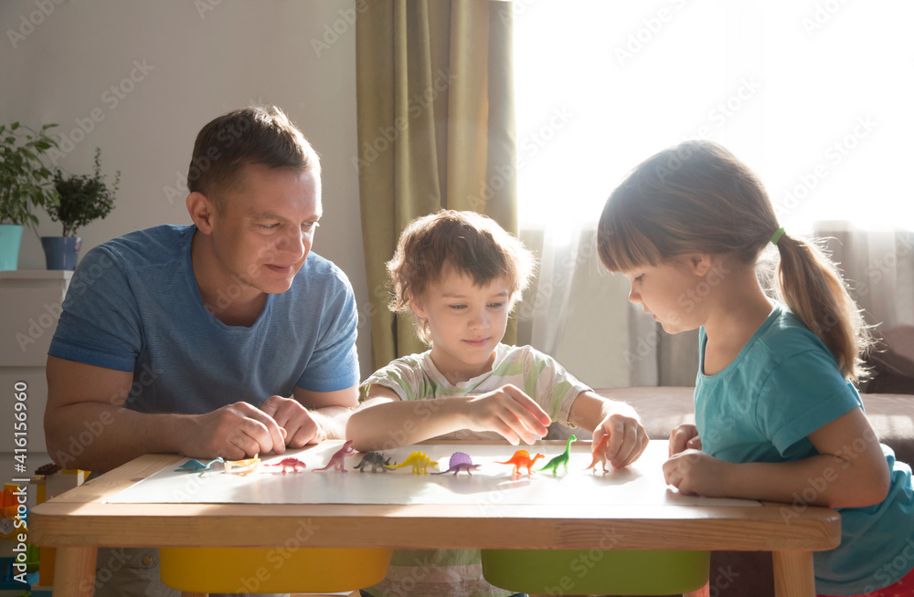 Dad with two kids playing animal figures together at home. Family having fun playing at home. stay home concept Dad with two kids playing animal figures together at home. Family having fun playing at home. stay home concept