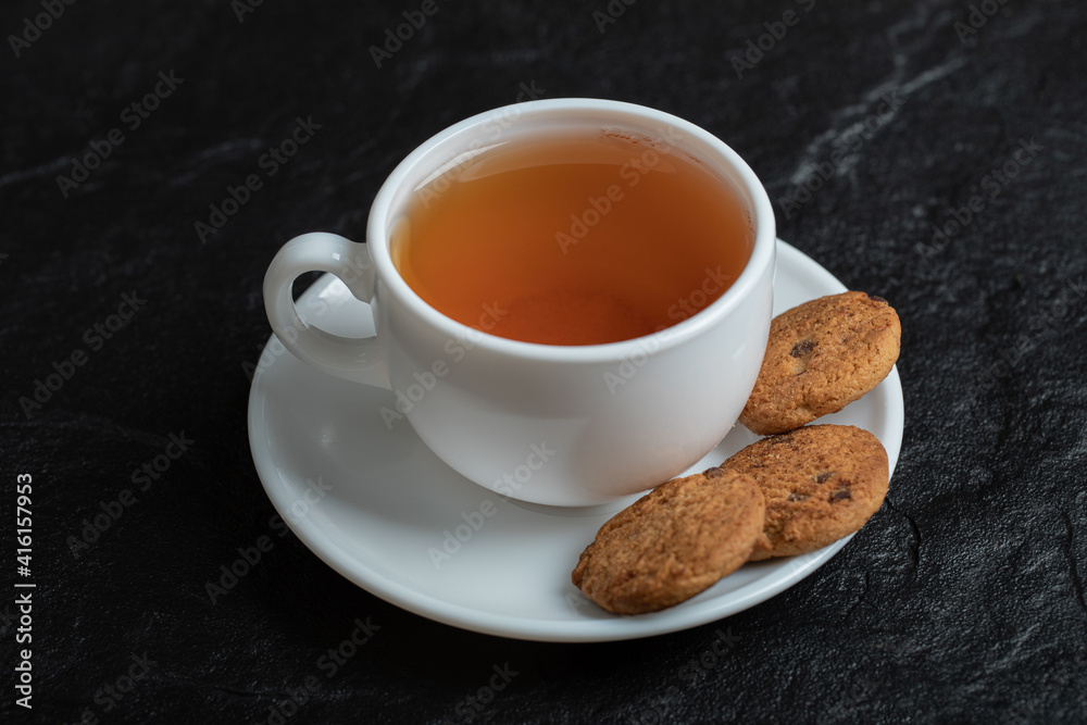 A cup of aroma tea with delicious cookies A cup of aroma tea with delicious cookies