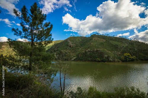 Landscape view of the lake with mountains background and beautiful clouds on the sky. Landscape view of Zezere river in Aldeias de Xisto, Portugal