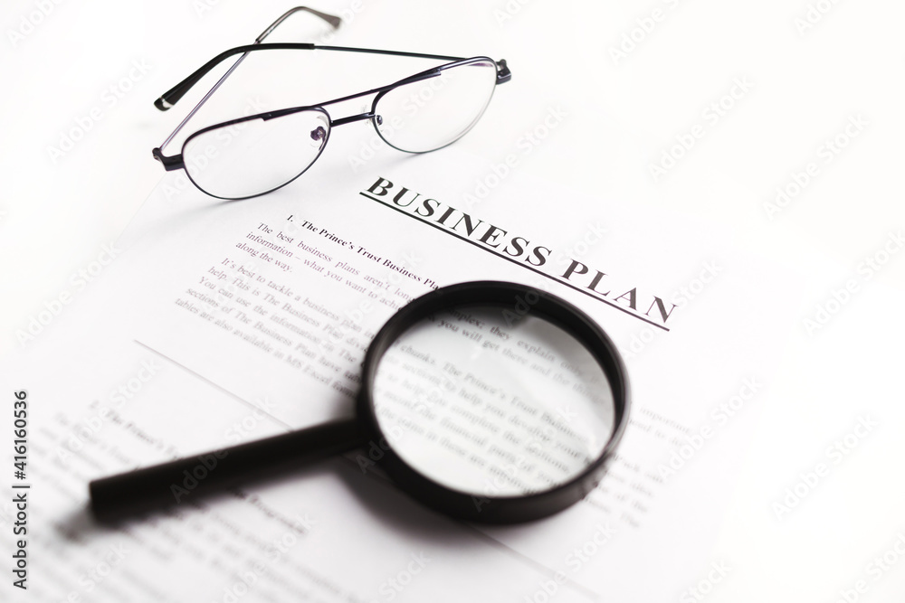 Business plan scrutiny concept. Flat lay on white table. Business plan scrutiny concept. Flat lay on white table.