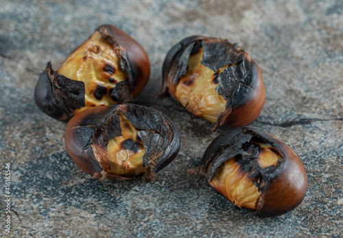 Fototapeta Naklejka Na Ścianę i Meble -  Delicious fried chestnuts on a marble background