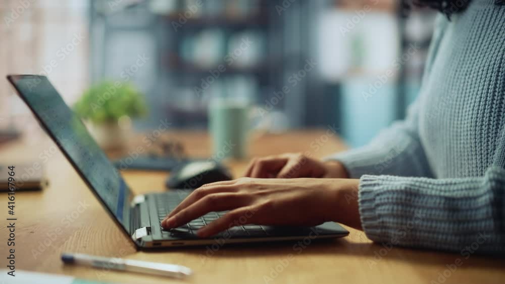 Close Up on Hands of a Female Specialist Working on Laptop Computer at Cozy Home Living Room while Sitting at a Table. Freelancer Woman Chatting Over the Internet on Social Networks.