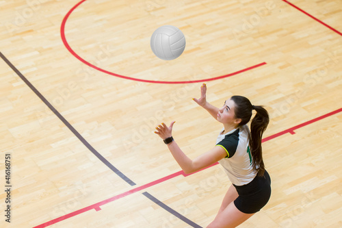 Upper View of Female Volleyball Player at Service. Team sport concept